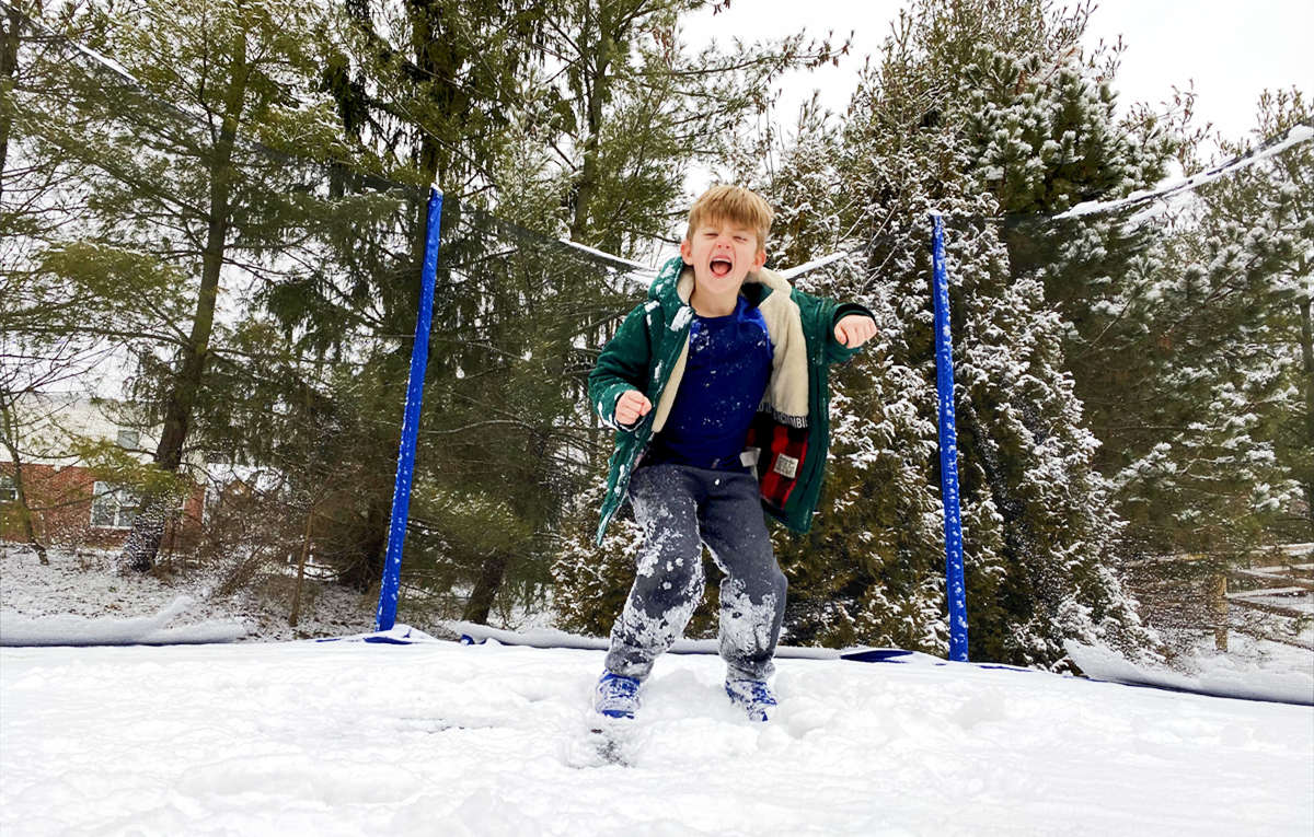 kids play trampoline in winter