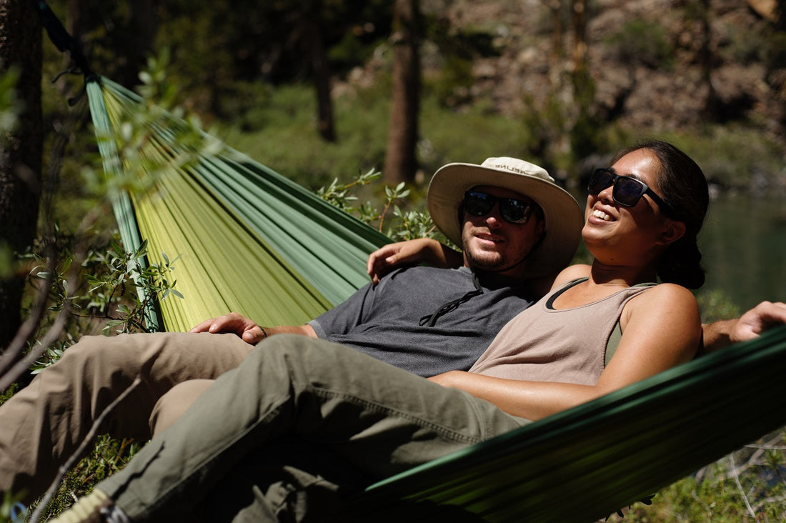 a couple on a zupapa double hammock when camping oudoors